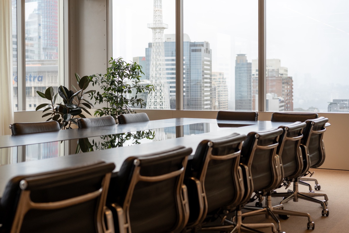 Modern Impruvu office workspace with sleek boardroom seating and city skyline views